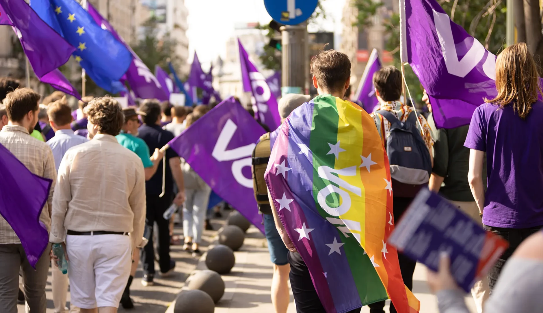 Volters marching in Bucharest with rainbow flag