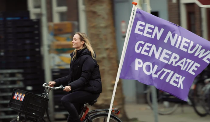 Volter riding a bike with a flag saying 