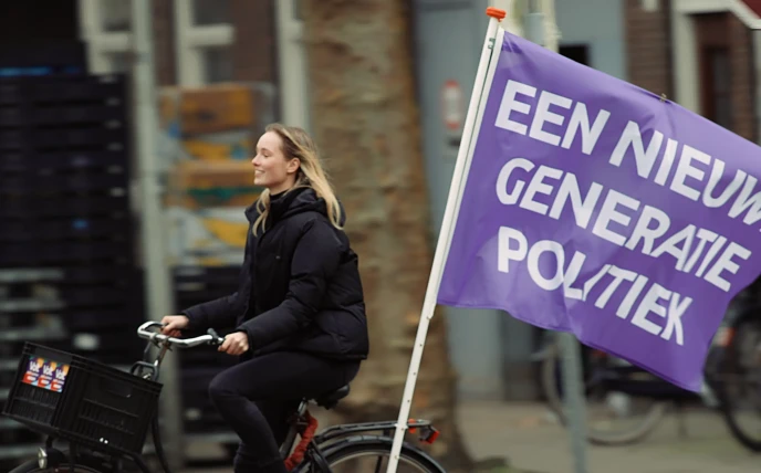 Volter riding a bike with a flag saying 